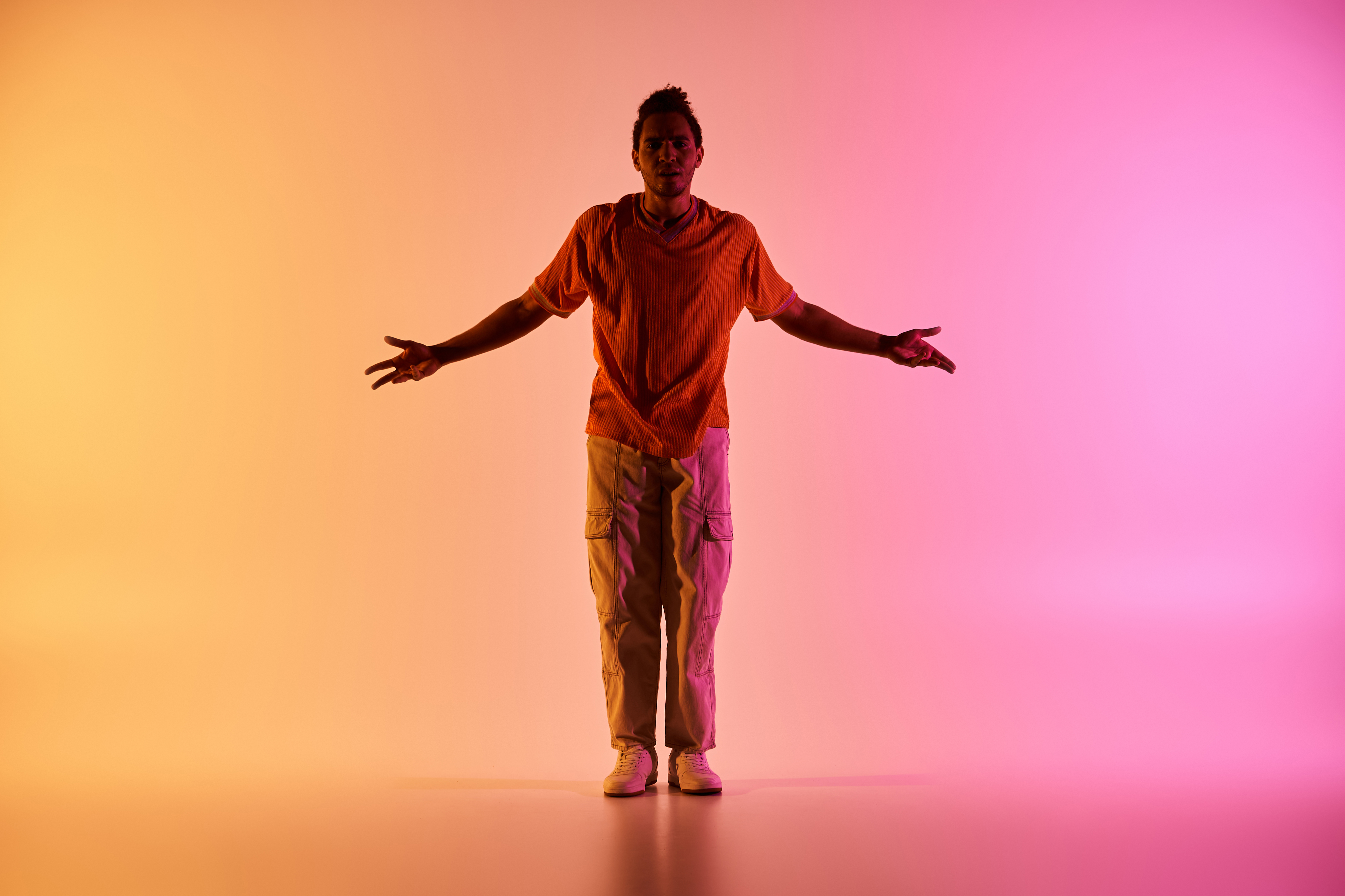 Person standing with arms open in light representing integration of three worlds and regulated nervous system