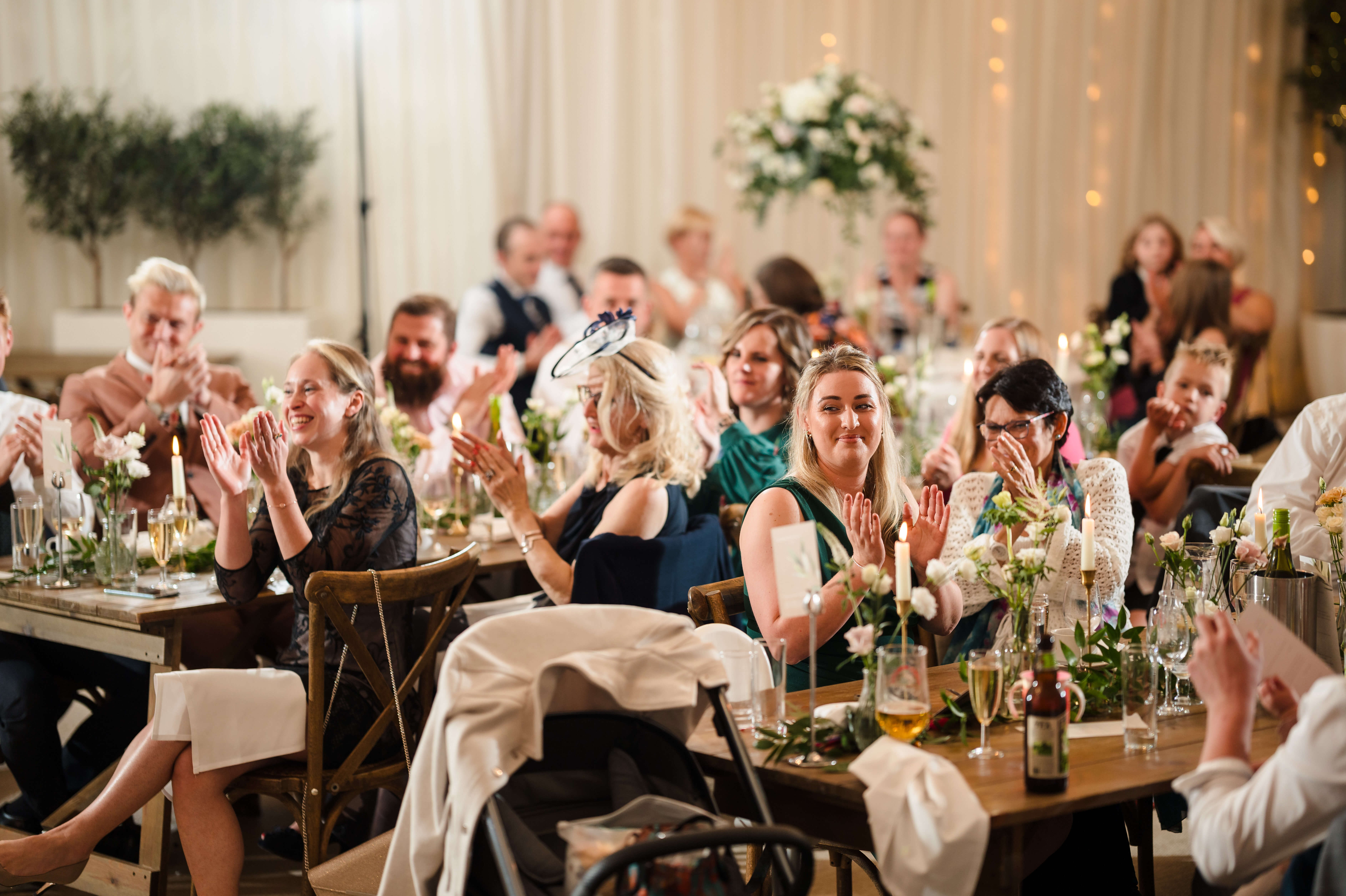 Guests watching an after-dinner magic show at a wedding