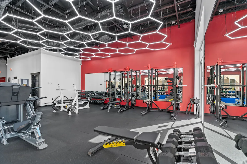 4F Coaching gym tour poster — the training floor under hex LED lights