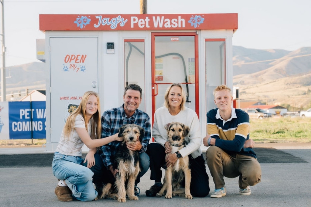 Family with two dogs in front of Jag’s Pet Wash 24/7 self-service pet wash station in Pocatello, Idaho.