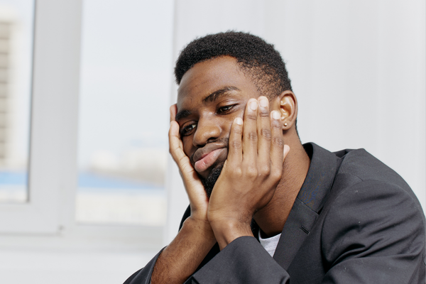 Professional sitting at desk looking tired and disengaged in an office. Professional sitting at desk looking tired and disengaged in an office.