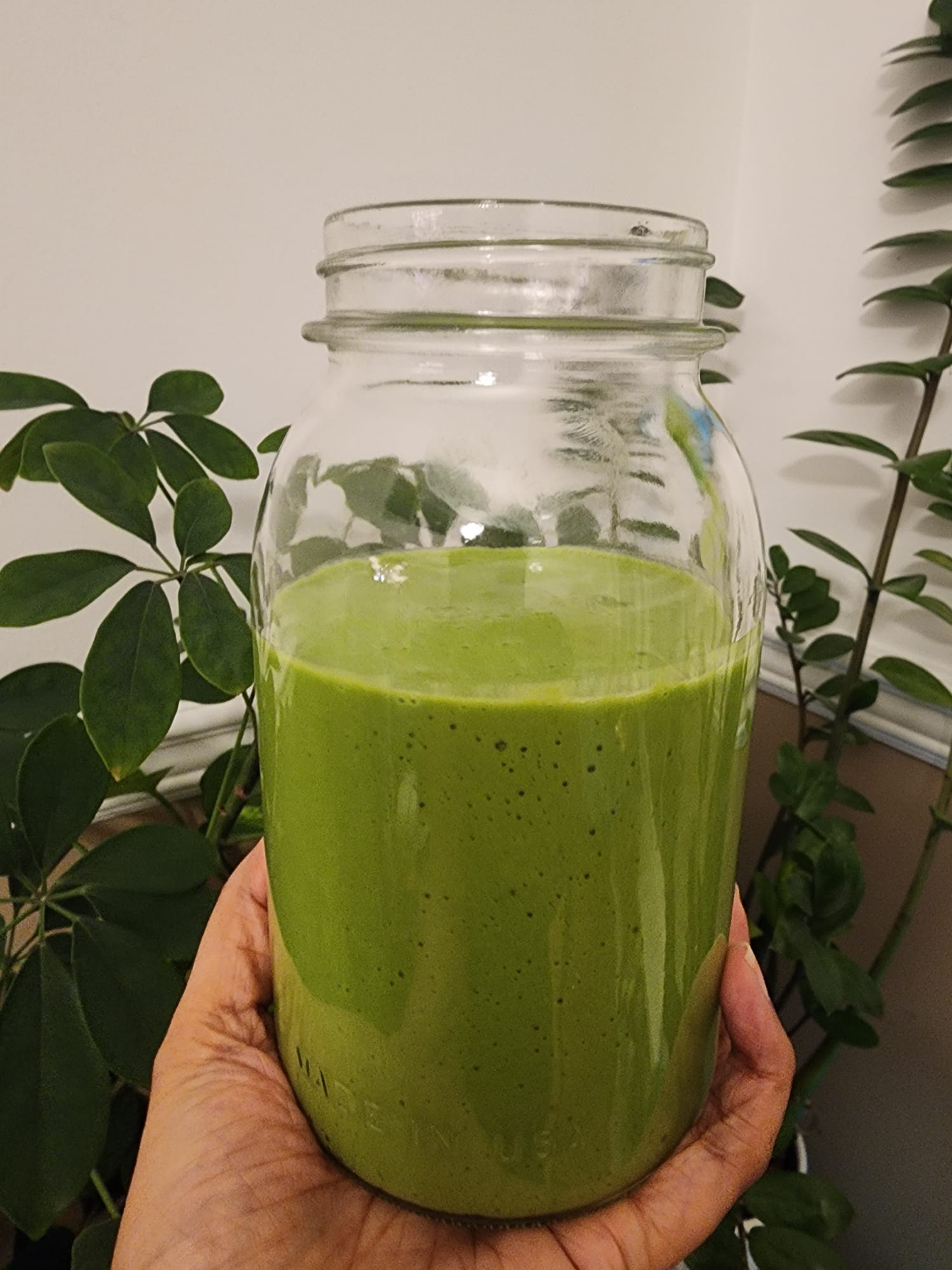 Nadia holding a fresh green smoothie