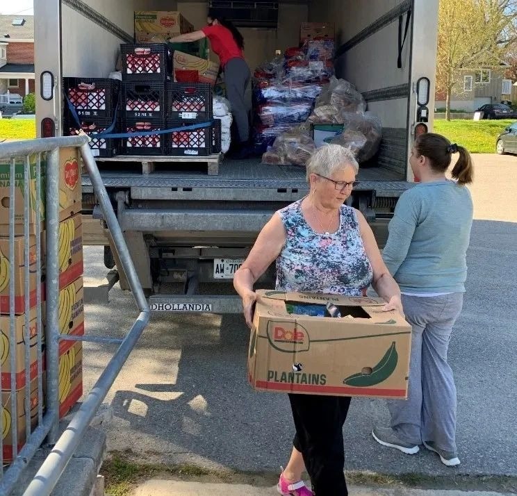 Volunteers unloading a delivery of food for the neighbourhood food ministry
