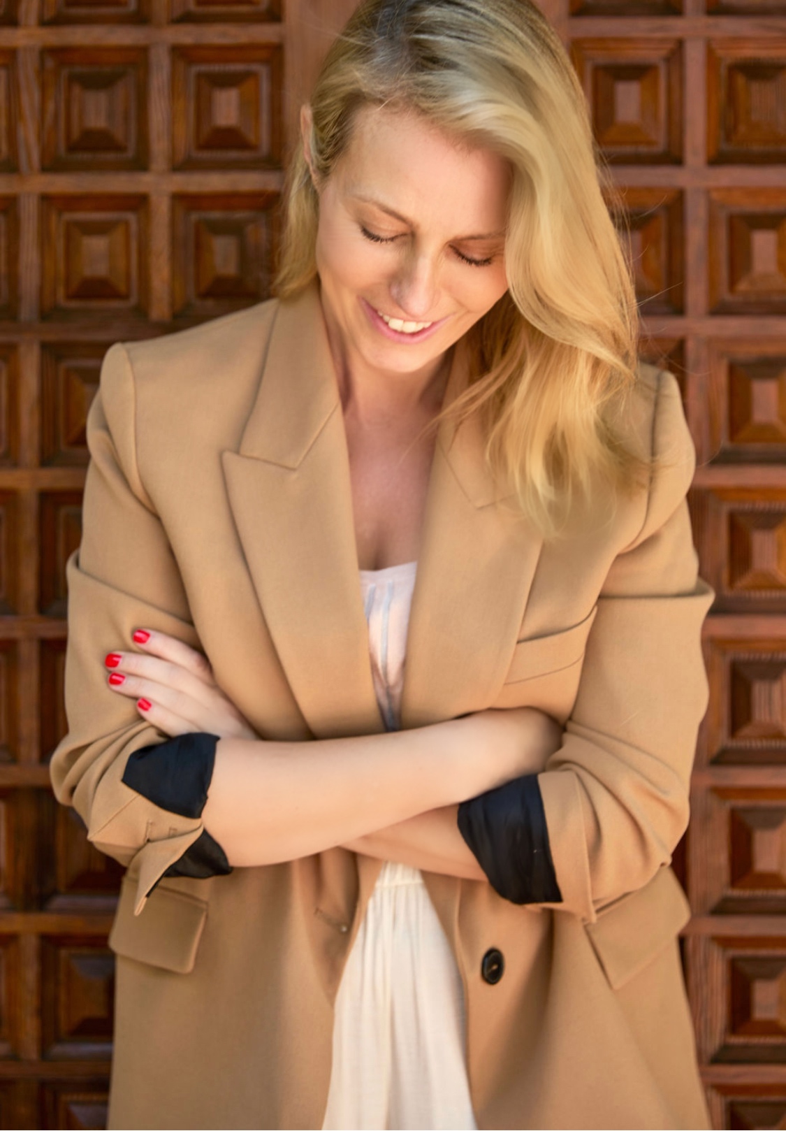 Flora Ong smiling in a tan blazer