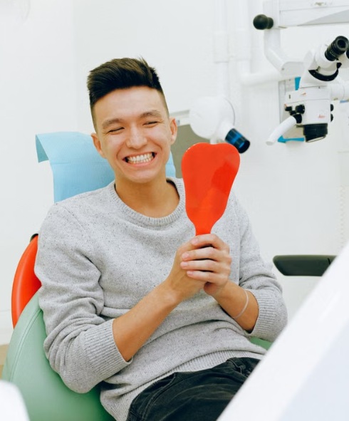 A Redwood Dental patient smiling at their new teeth