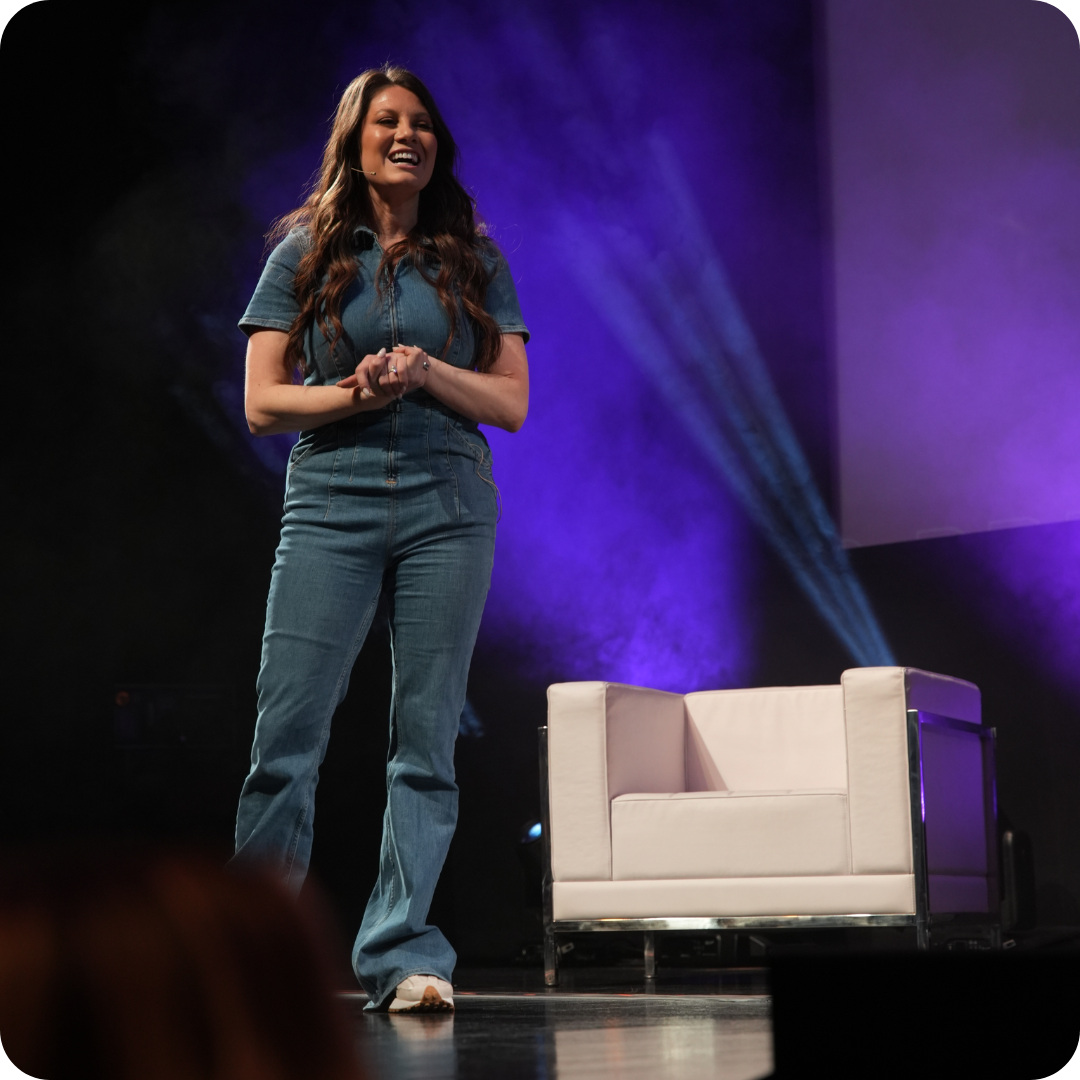 Desi Williams speaking on stage Desi Williams speaking on stage
