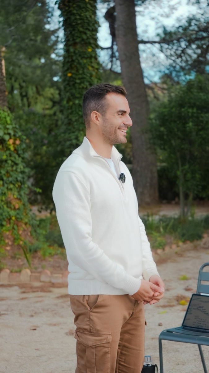 Aleix de pie en el jardín durante una charla, sonriendo