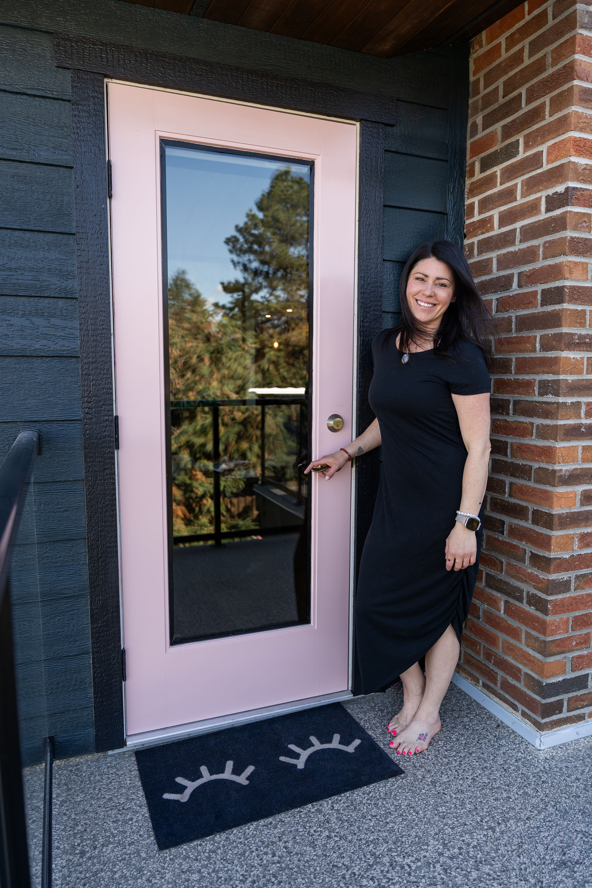 Andrea outside by door
