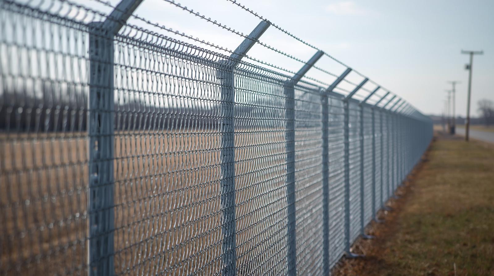 Industrial security fencing with barbed wire installed at manufacturing facility in Northern Illinois. Industrial security fencing with barbed wire installed at manufacturing facility in Northern Illinois.