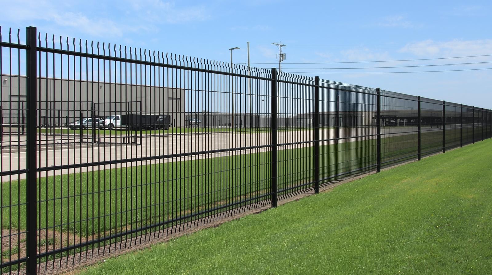 Industrial security fence installation around warehouse facility in Northern Illinois.