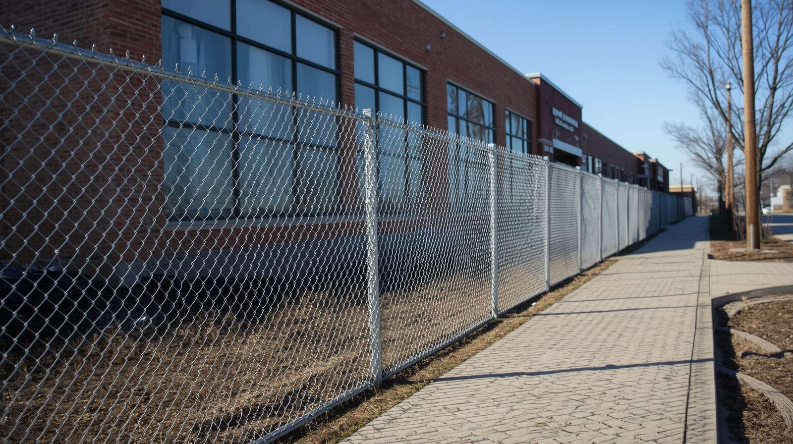 Commercial fence installed near property line boundary in Illinois.