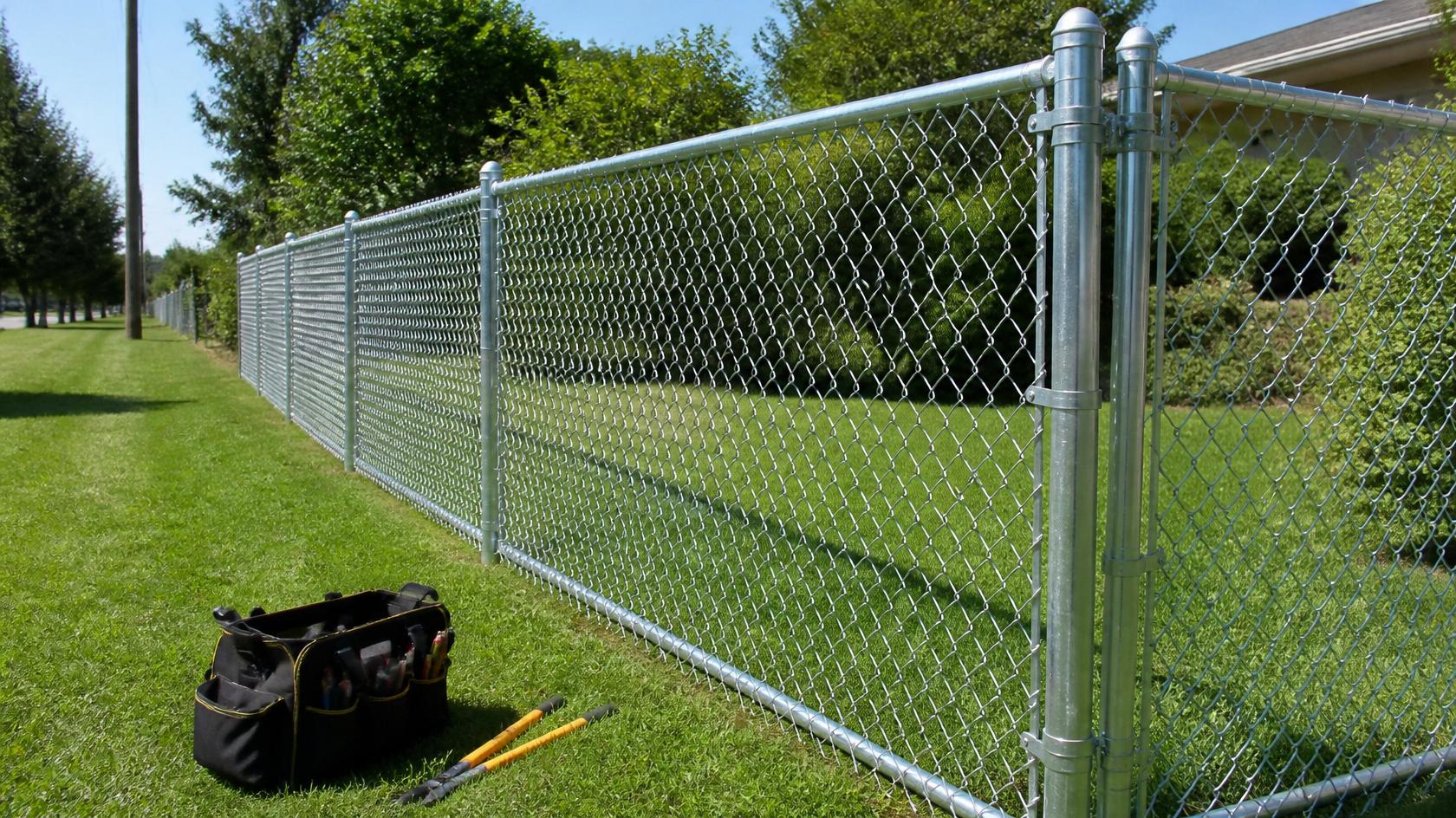 Contractor performing chain link fence maintenance in Turtle, WI to keep the property secure.