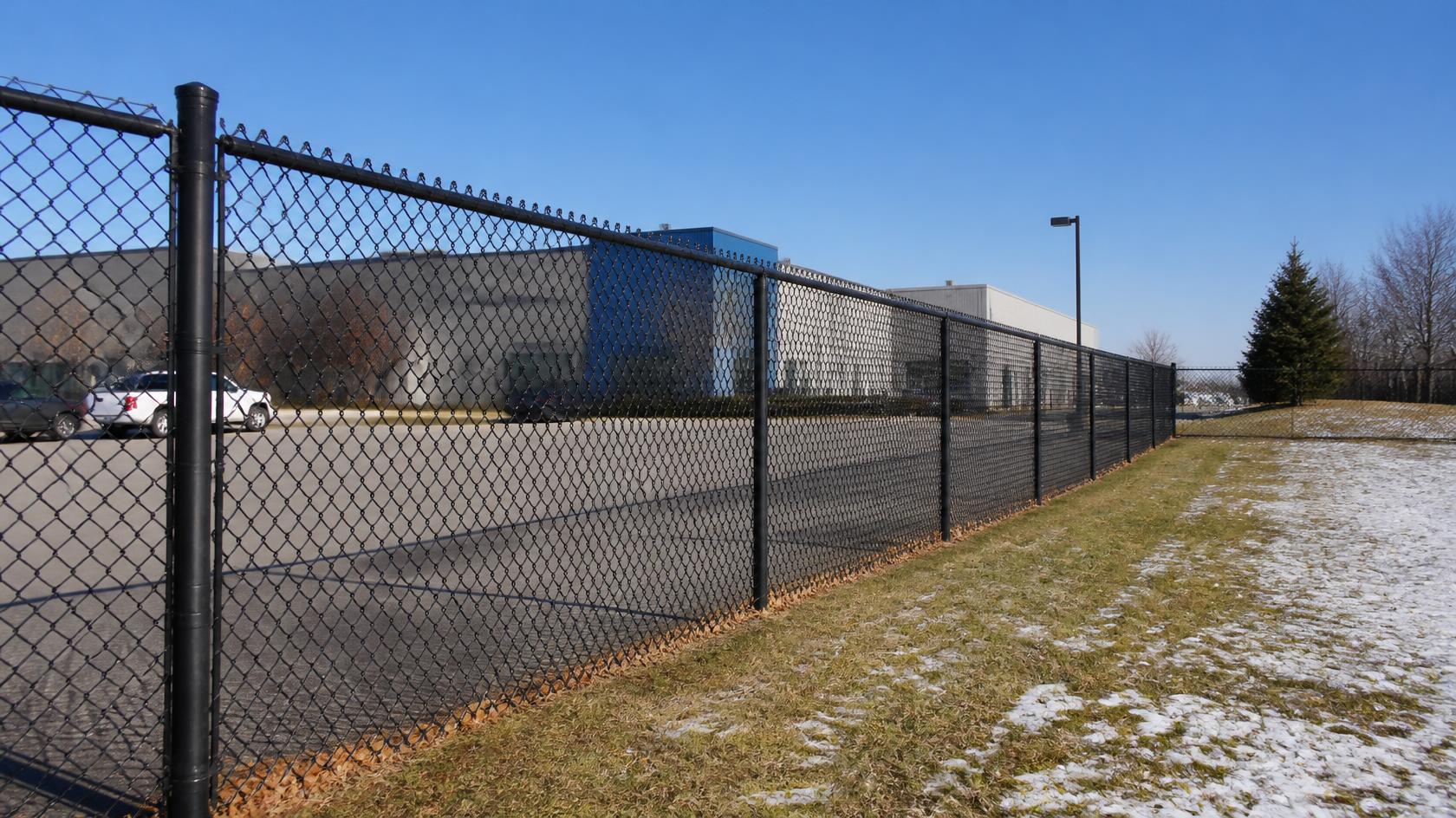 Chain link fence in Rockford, IL being inspected for common problems such as damaged mesh, loose posts, and worn sections. Chain link fence in Rockford, IL being inspected for common problems such as damaged mesh, loose posts, and worn sections.