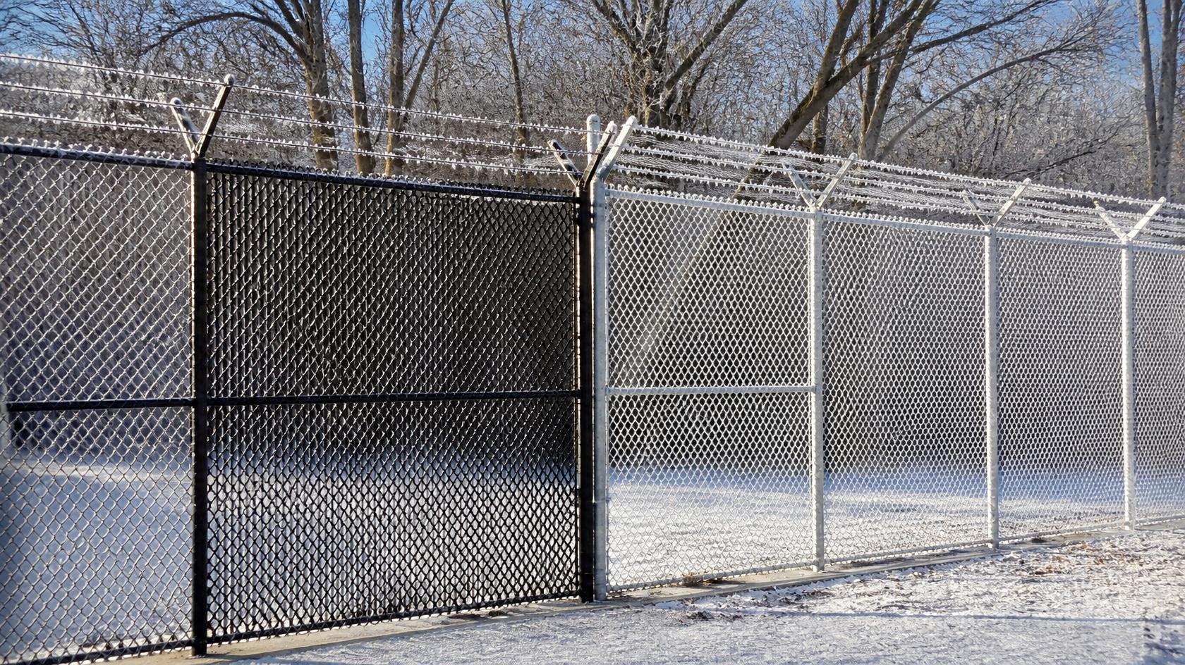 Commercial security fence in Belvidere, IL being inspected for repair, replacement, and winter readiness to maintain perimeter protection. Commercial security fence in Belvidere, IL being inspected for repair, replacement, and winter readiness to maintain perimeter protection.