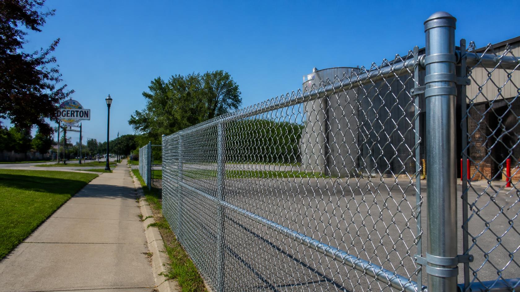 Commercial chain link fence project in Edgerton, WI with property owners reviewing fence length, materials, gates, labor, and other 2026 budget factors. Commercial chain link fence project in Edgerton, WI with property owners reviewing fence length, materials, gates, labor, and other 2026 budget factors.