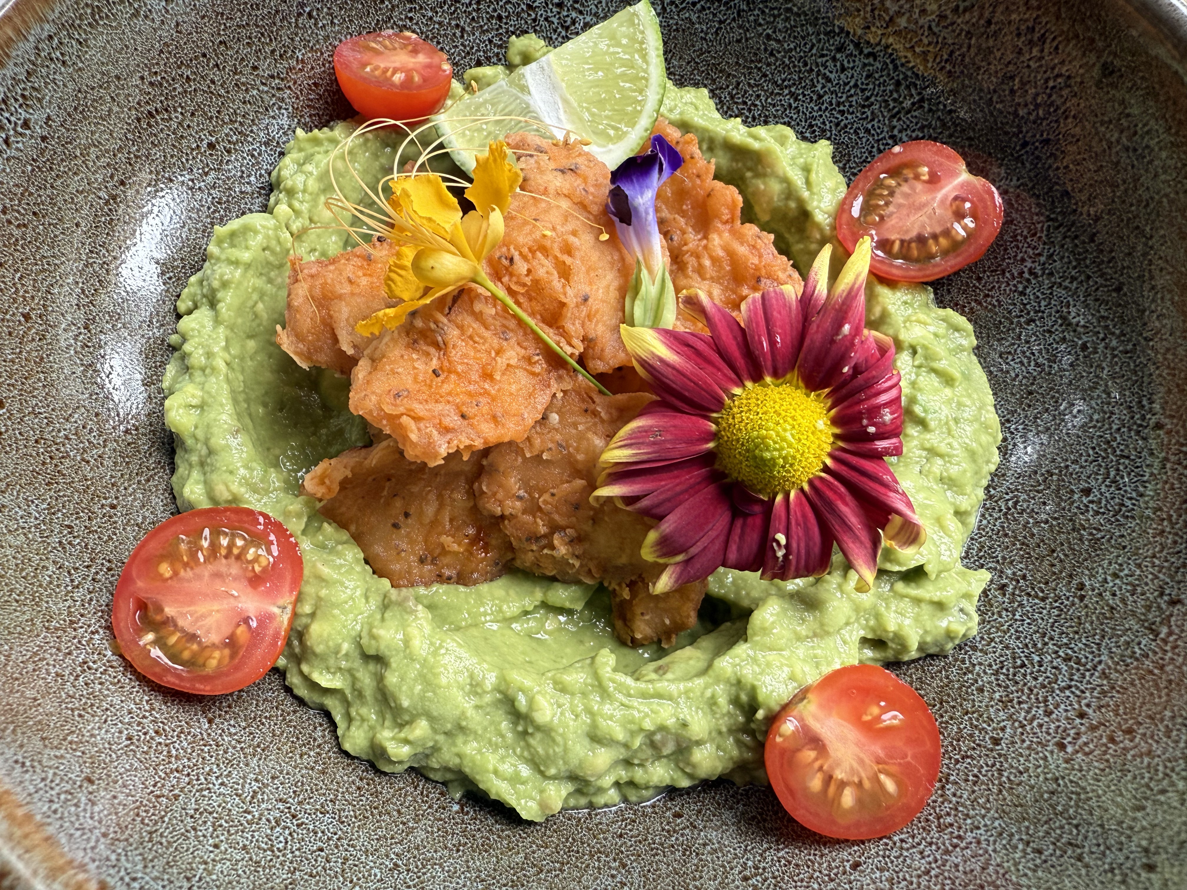Plated dish with flowers and fresh ingredients