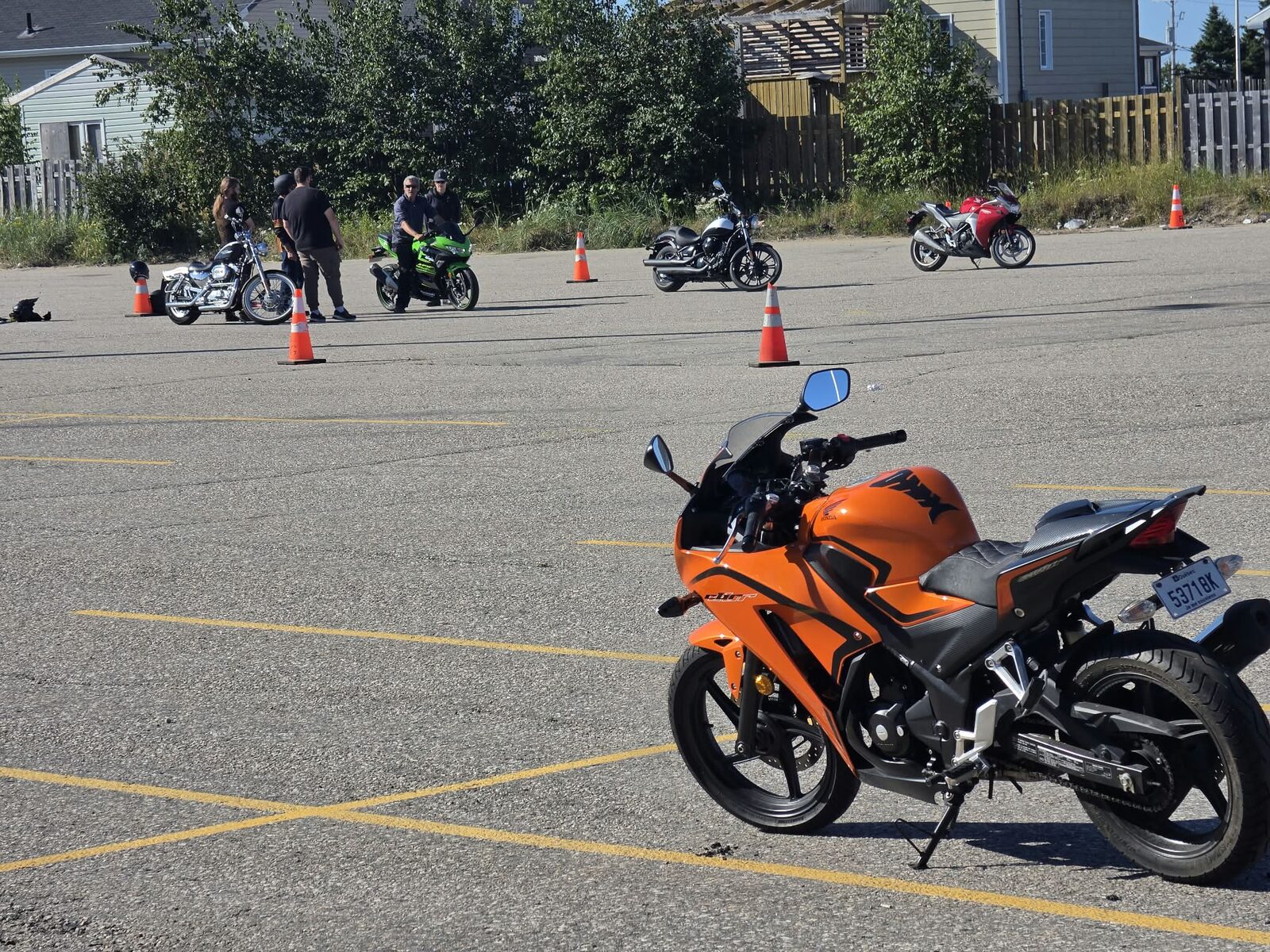 Deux élèves à moto en exercice, l'un sur une moto verte et l'autre sur une moto noire