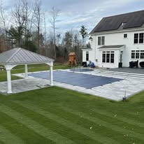 Pavilion with pool and patio by American Landscape Construction