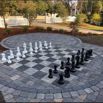 Custom chess board paver patio by American Landscape Construction