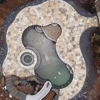 Custom water feature and pond by American Landscape Construction
