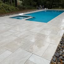 Large format stone pool patio by American Landscape Construction