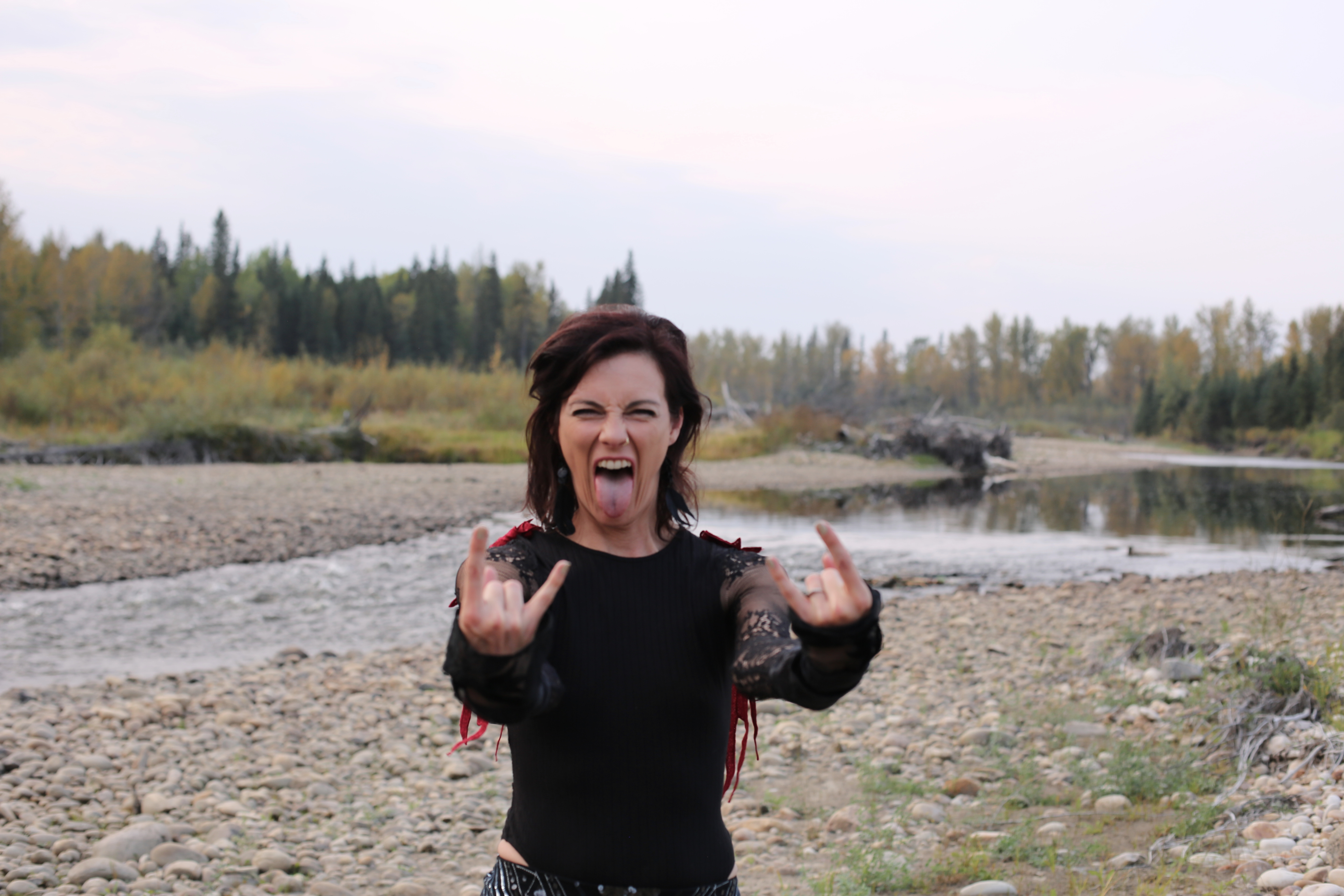 Wild and unapologetic on the riverbed, horns up and tongue out