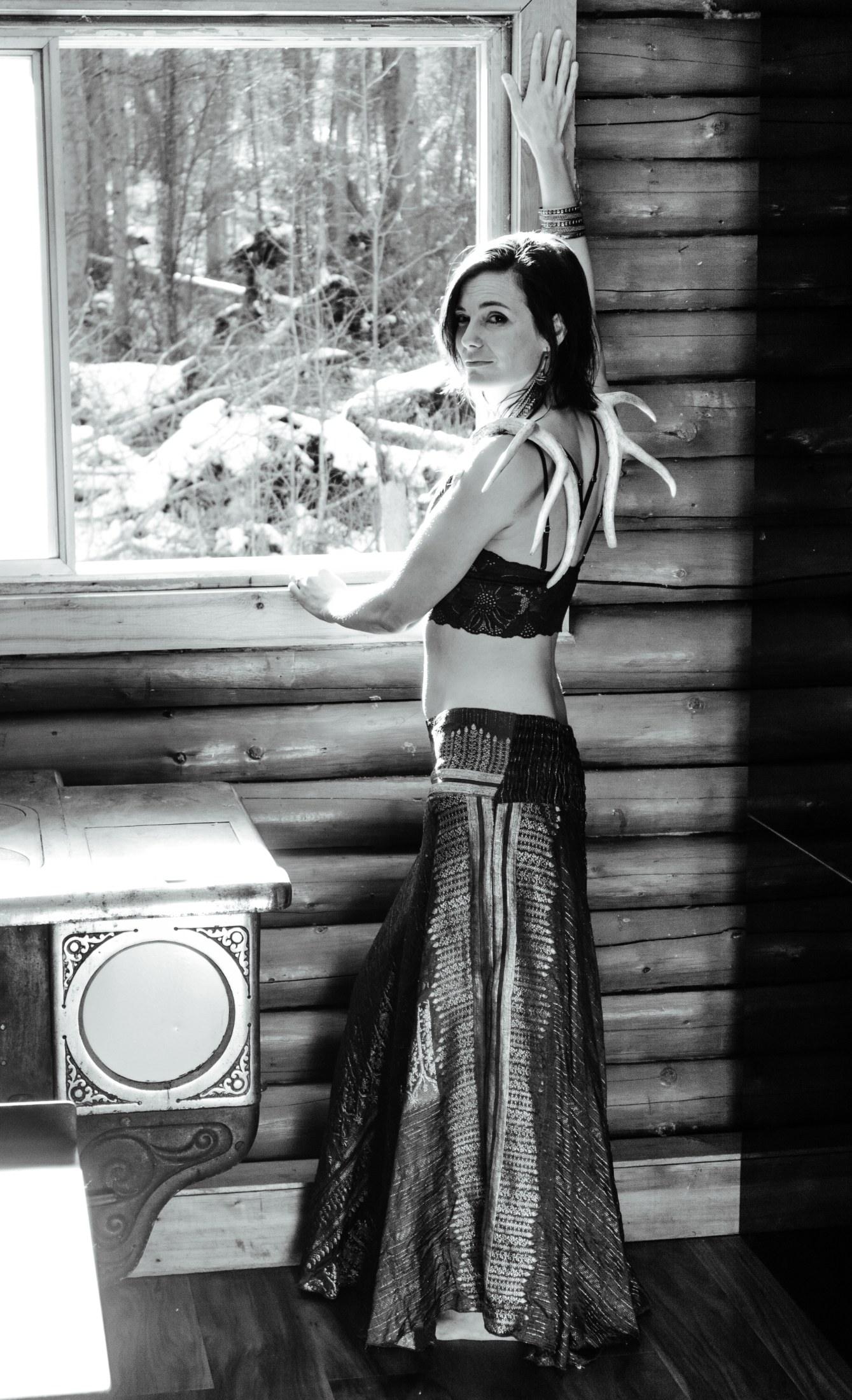 Black-and-white portrait at the cabin window
