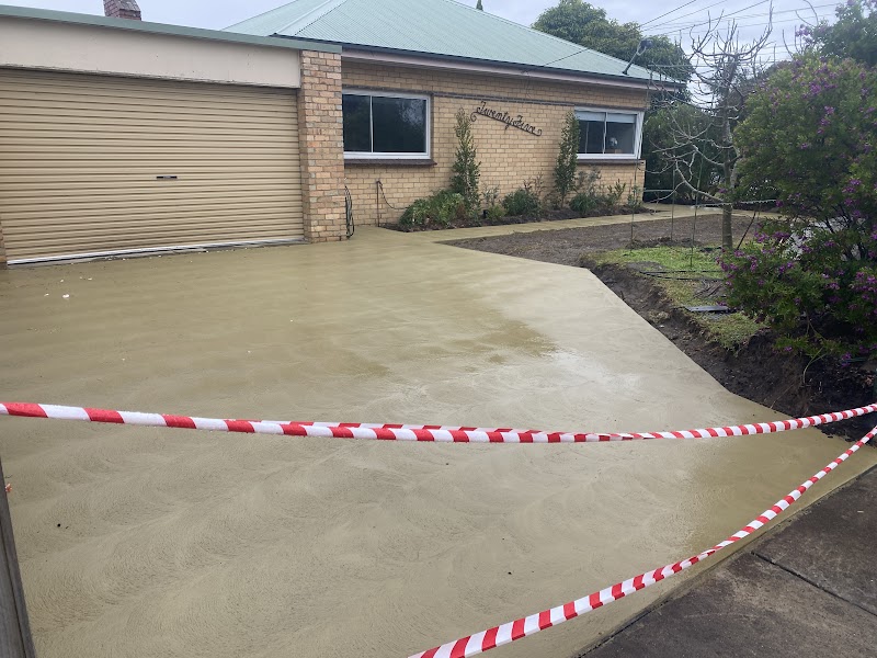 Plain concrete driveway beside home