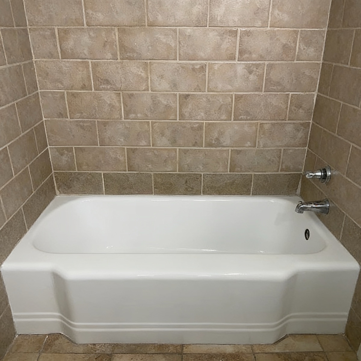 The same bathtub after refinishing: glossy, bright white
