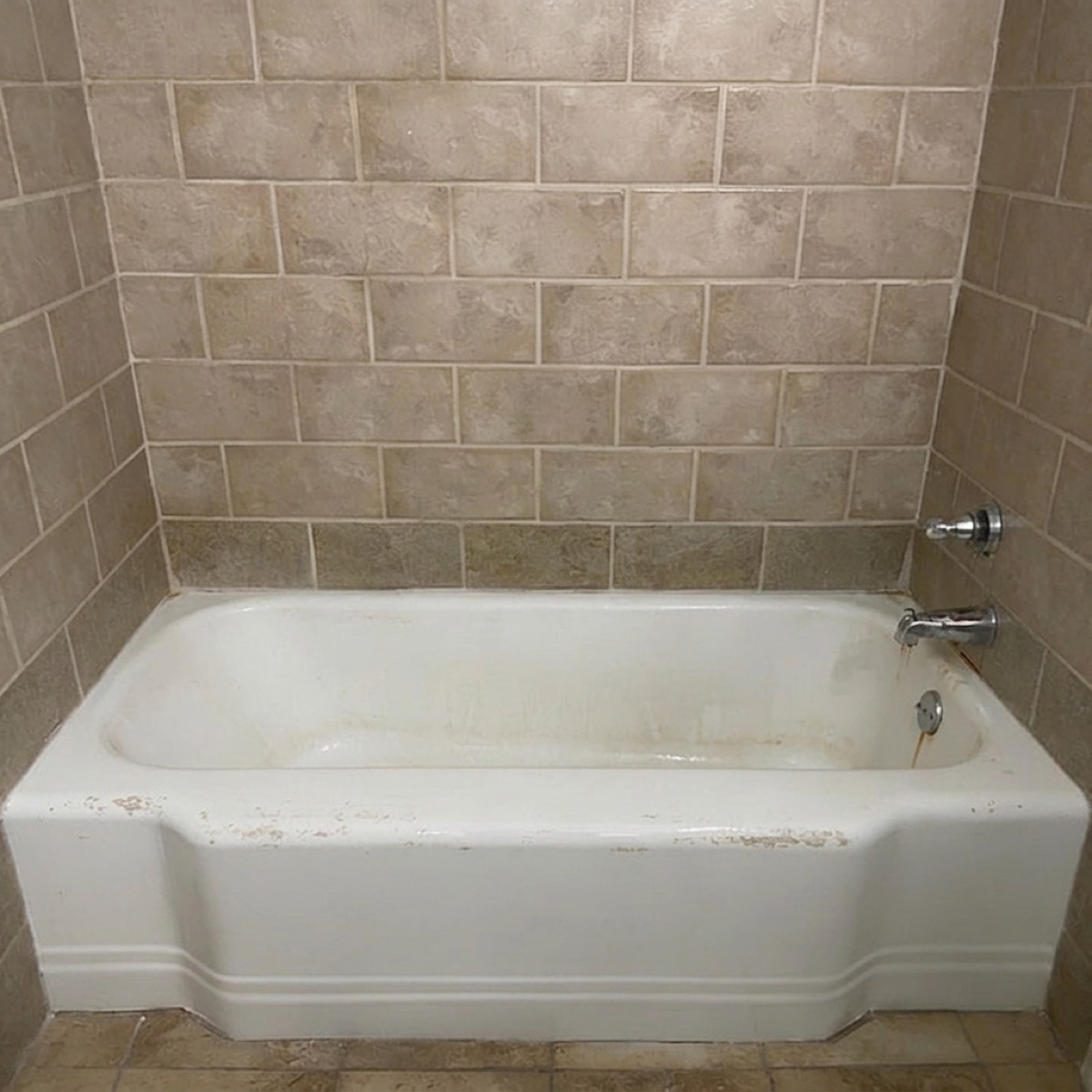 Bathtub before refinishing: stained, chipped, and dull