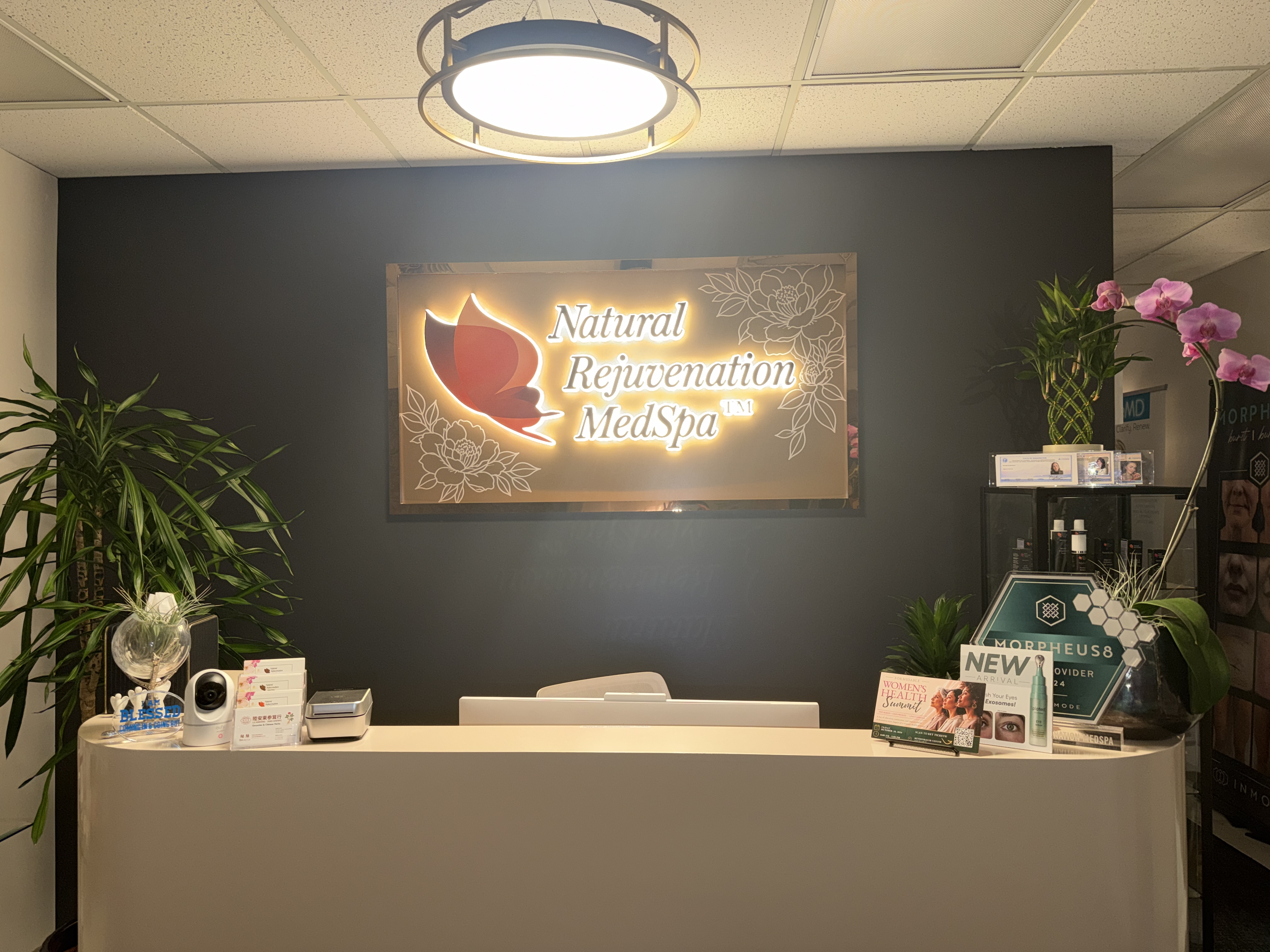 Reception desk and illuminated Natural Rejuvenation MedSpa sign in Bellevue.