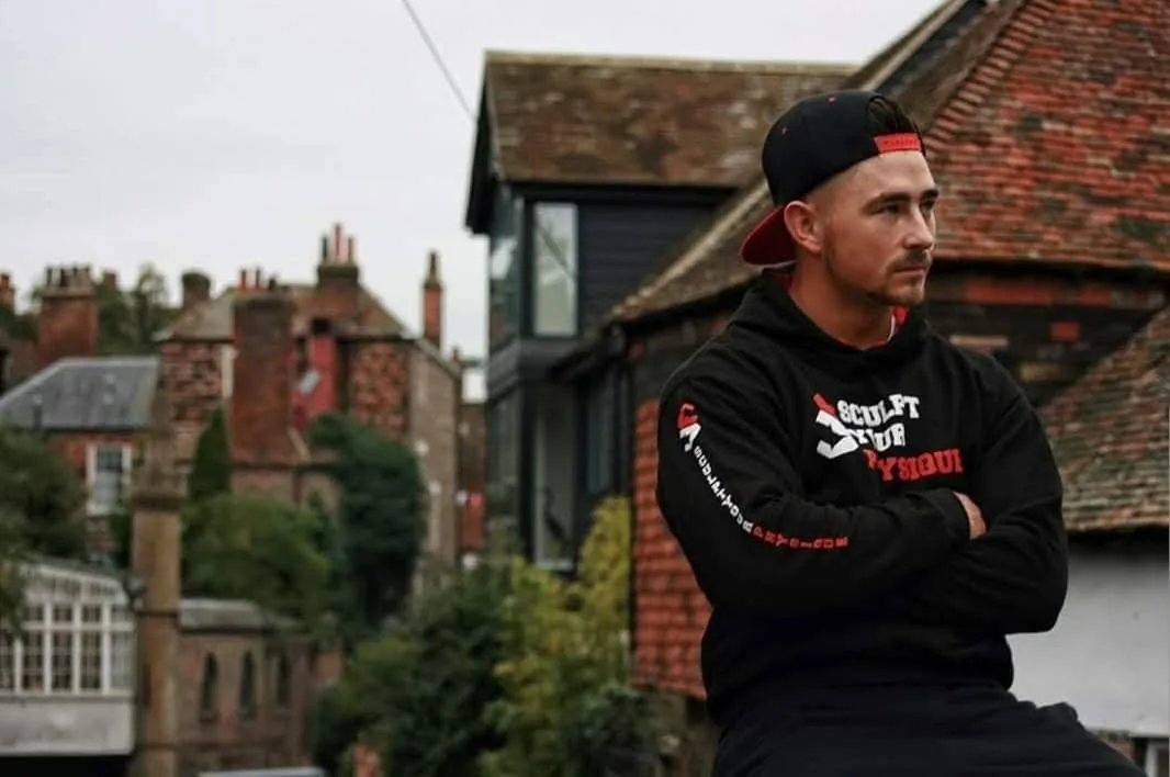 Mariusz Cichon, sports therapist and personal trainer at Sculpt Your Physique Coventry, wearing a black SYP hoodie