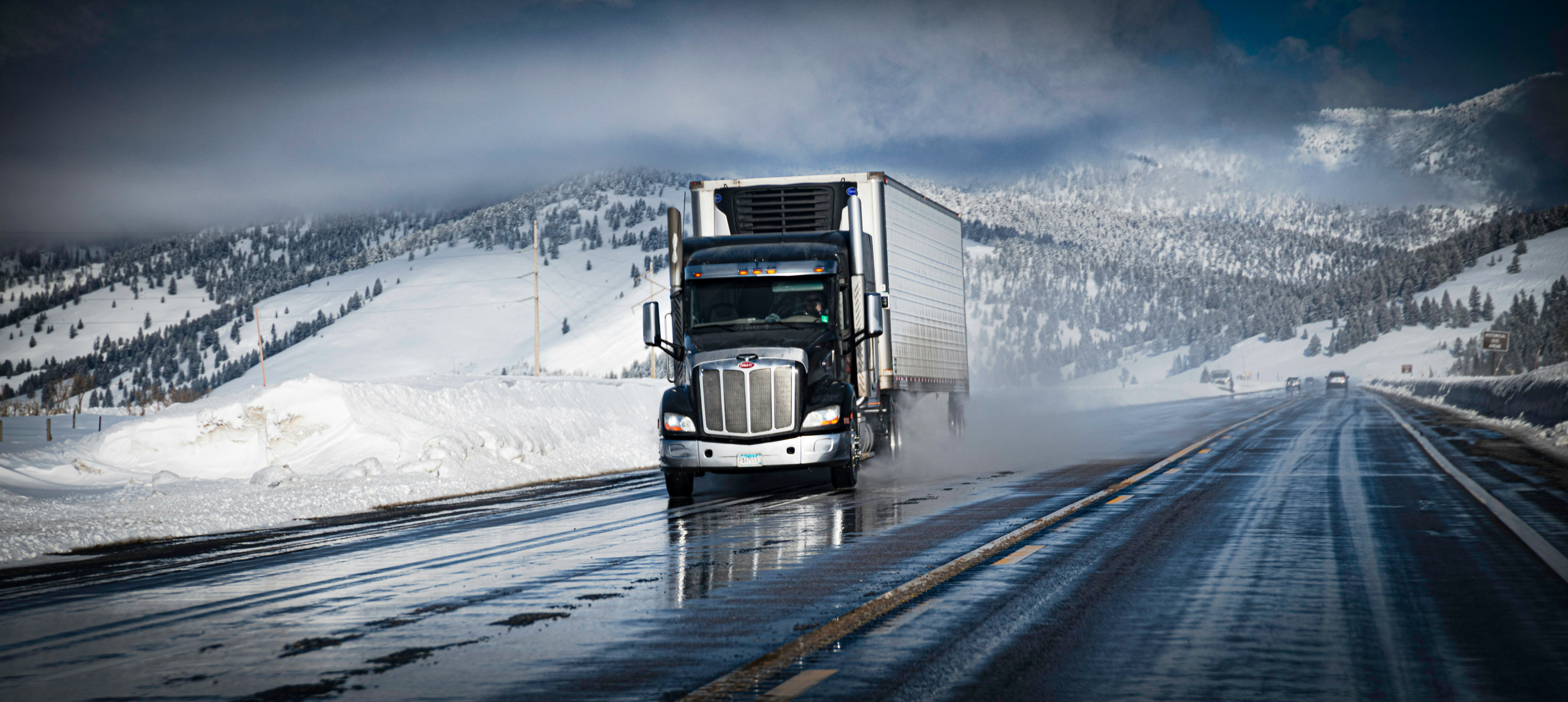 Semi-truck on the I-80 highway corridor in Northeast Ohio approaching the Pennsylvania state line
