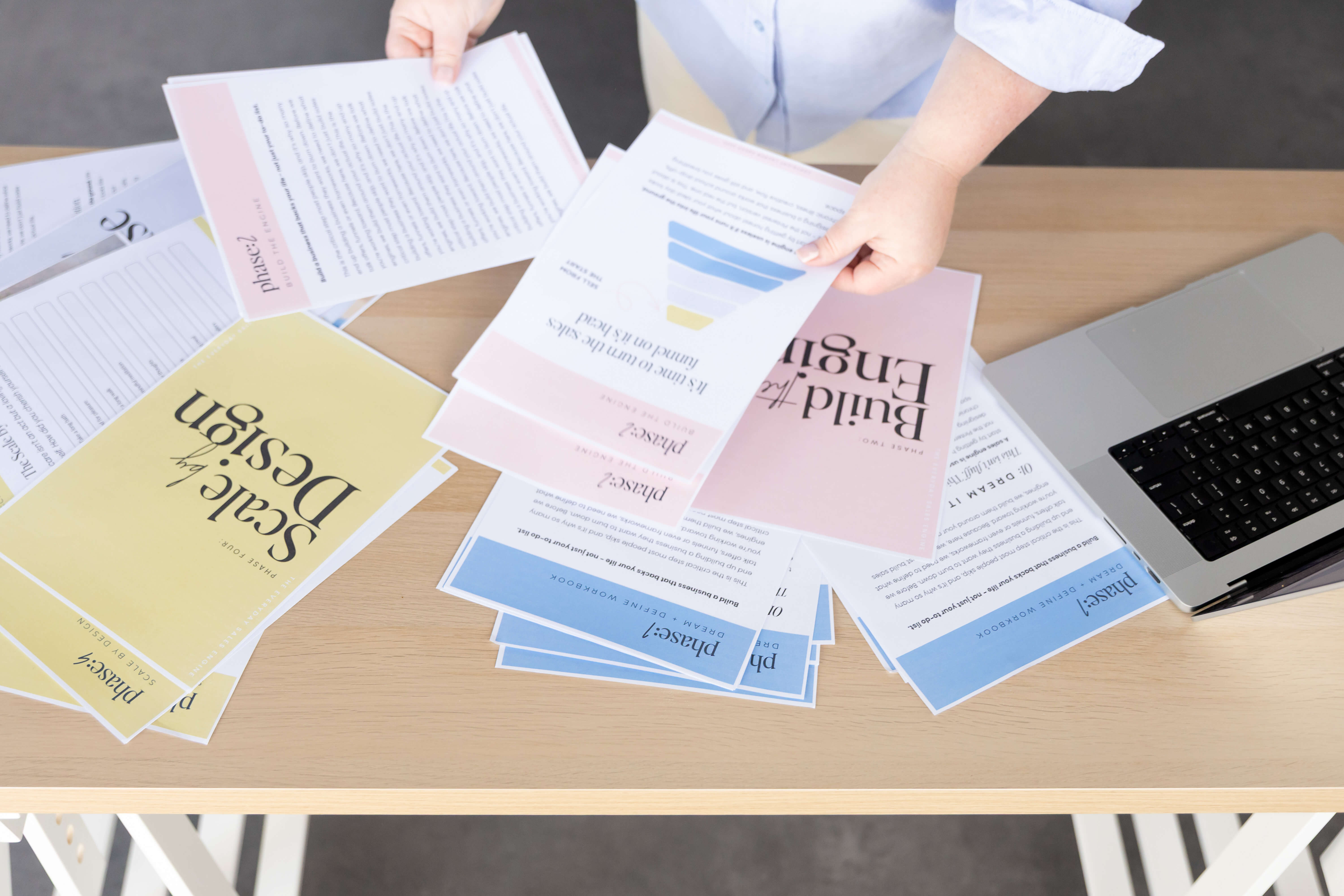 Everyday Sales Engine workbooks spread across a desk