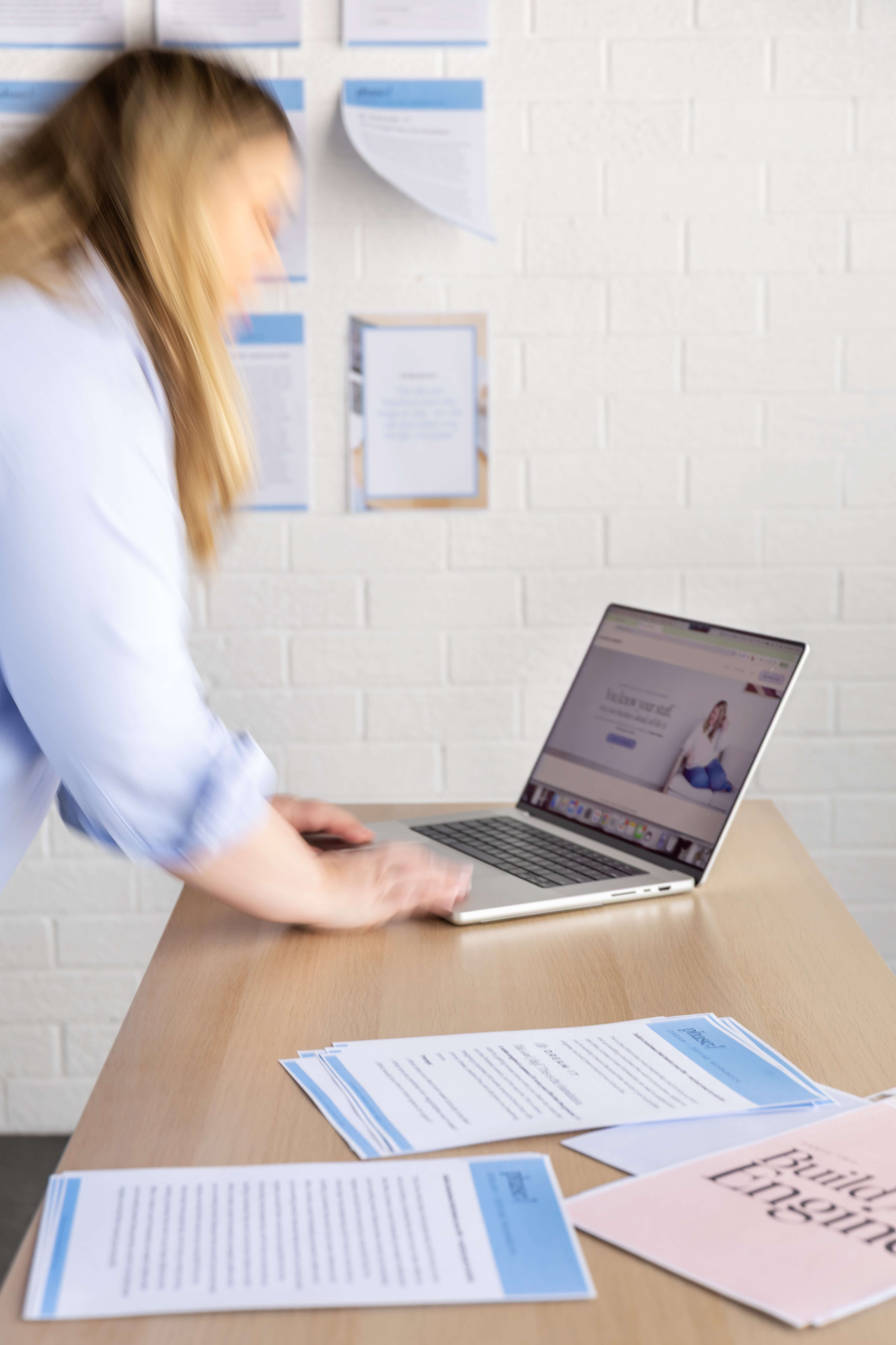 Lauren at her desk working on a sales page