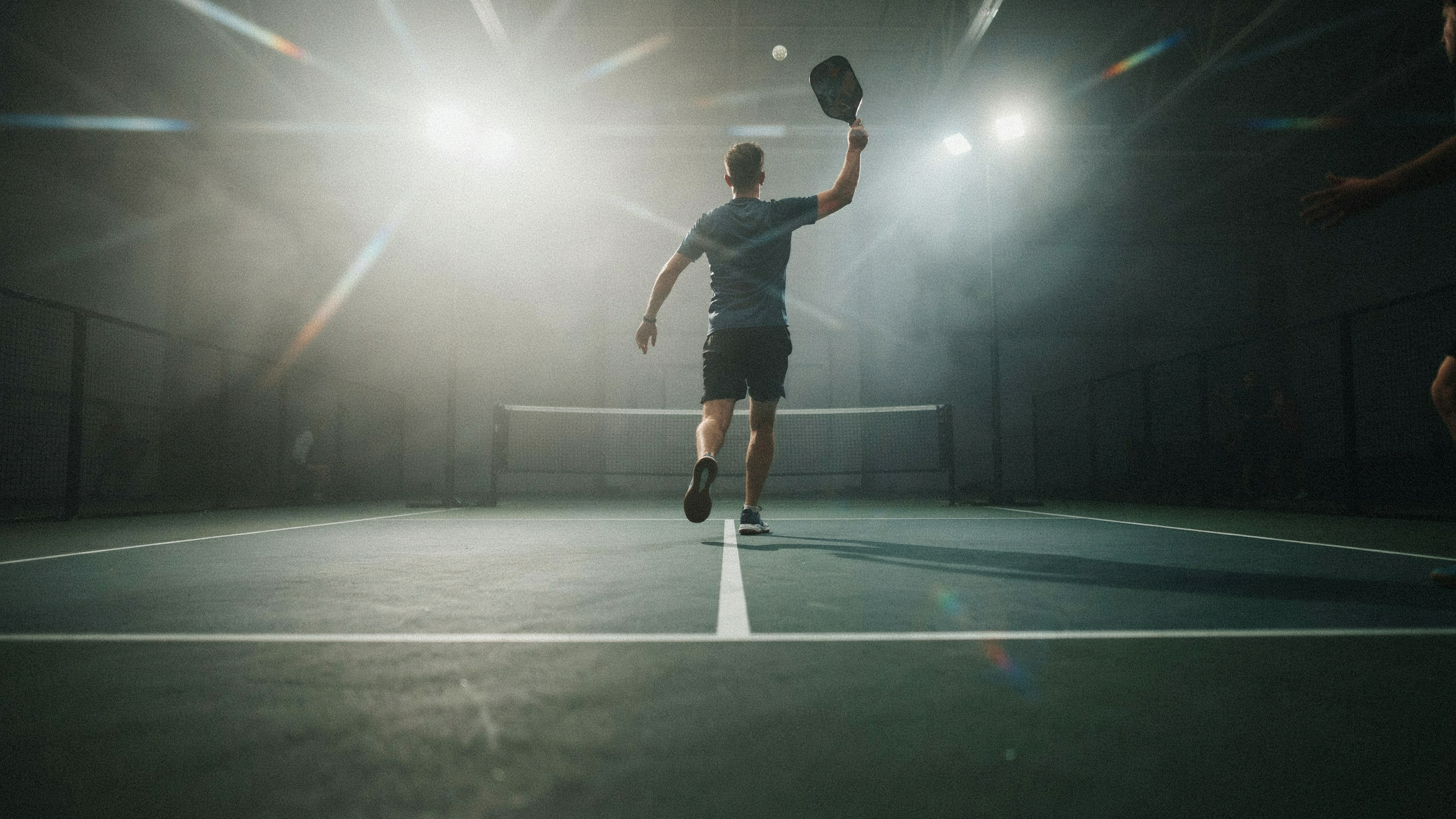 Open play session on an indoor pickleball court