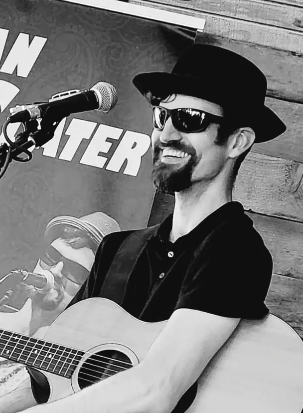 Sean Slater performing with his acoustic guitar