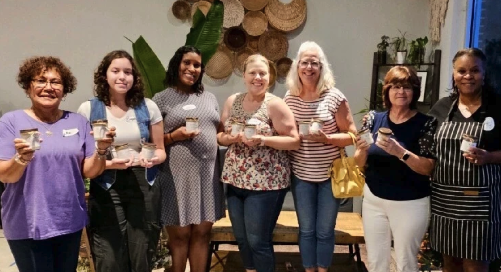 Smiling group of women at a Be a Light candle-making class