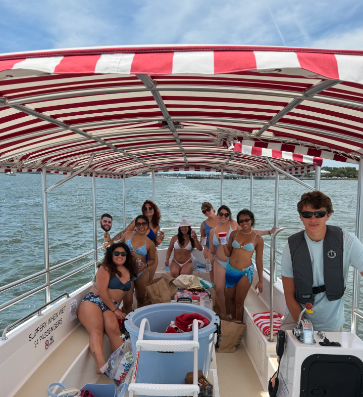 A family enjoying a day on a pontoon on Lake Norman