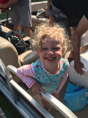 A family enjoying a day on a pontoon on Lake Norman