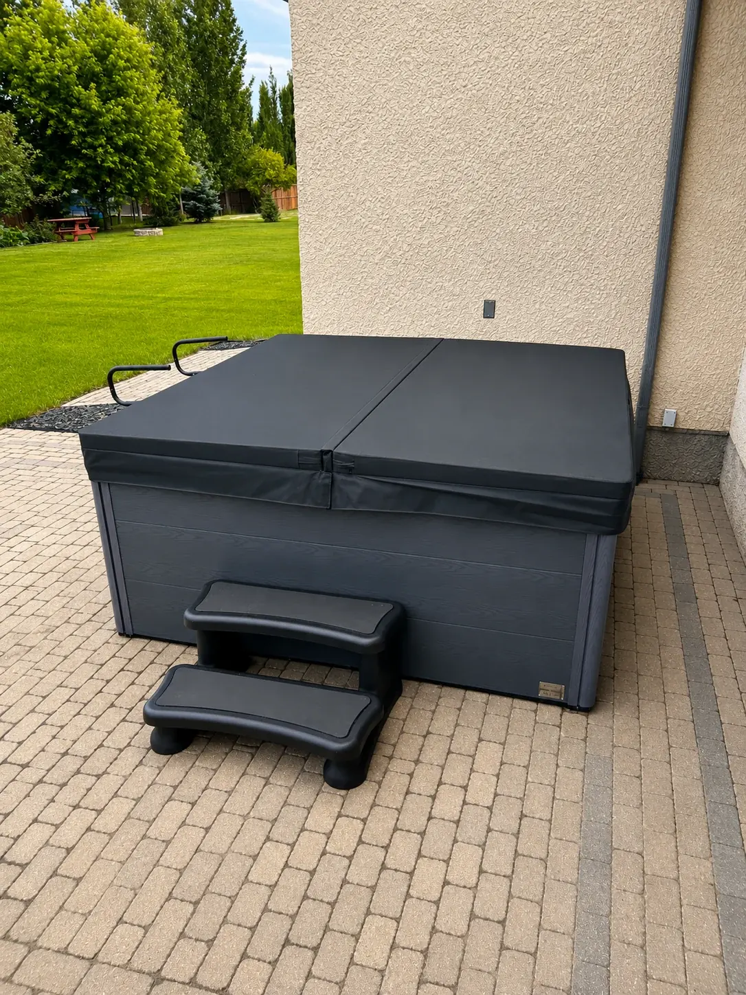 Finished covered hot tub setup with dedicated entry steps