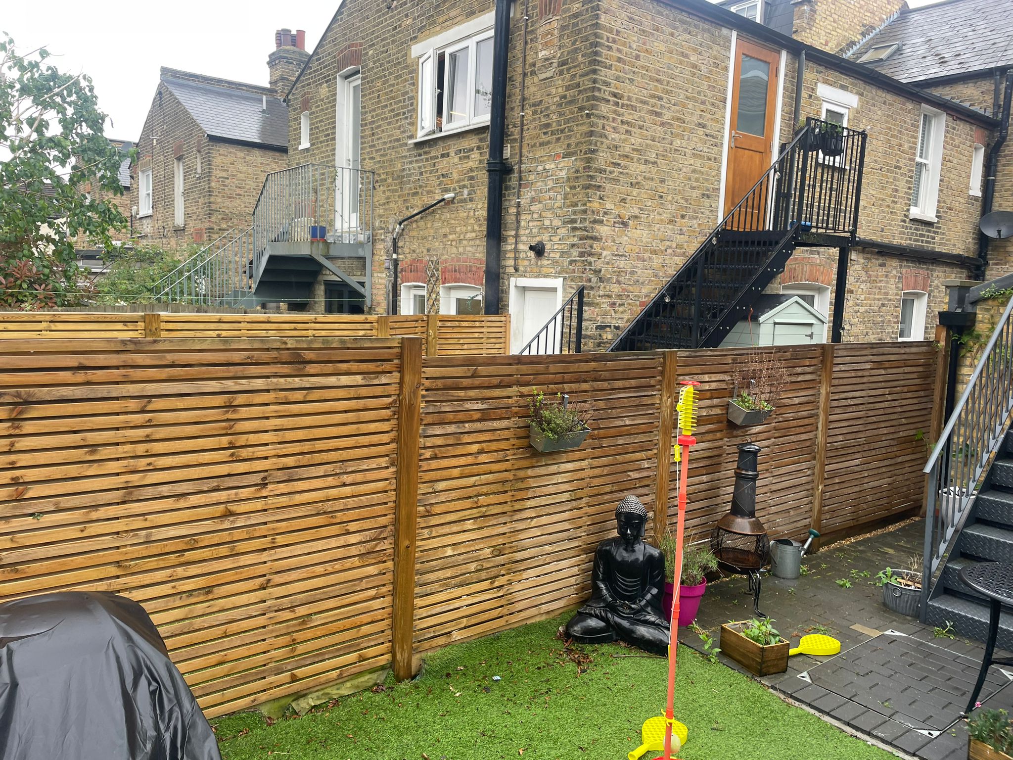 SouthWest Fencing team installing a durable closeboard fence on a residential property in London.