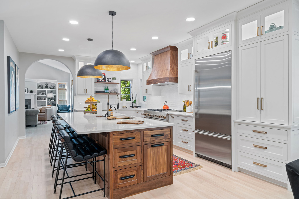 Well lit Kitchen with island counter and wooden cabinets Well lit Kitchen with island counter and wooden cabinets