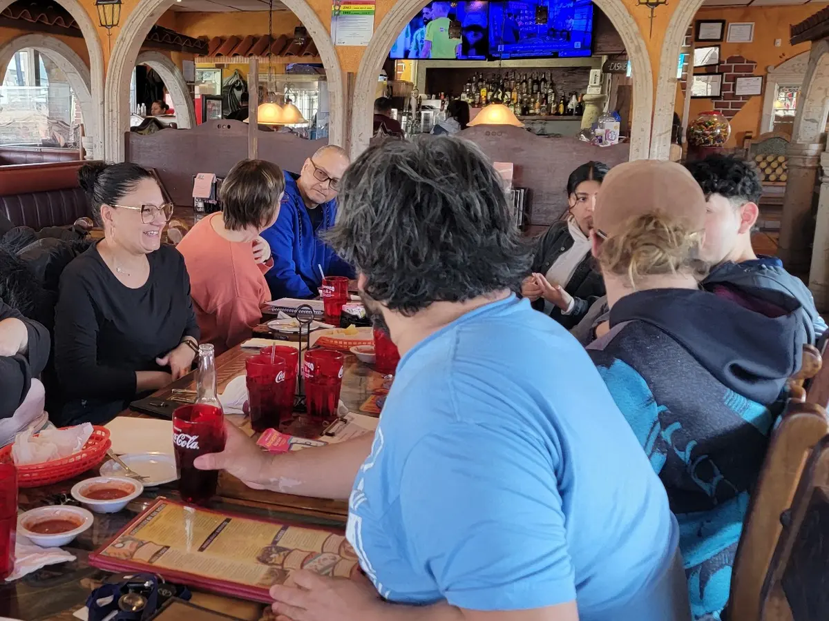 EPIC Spanish Bootcamp participants practicing together during a restaurant experience