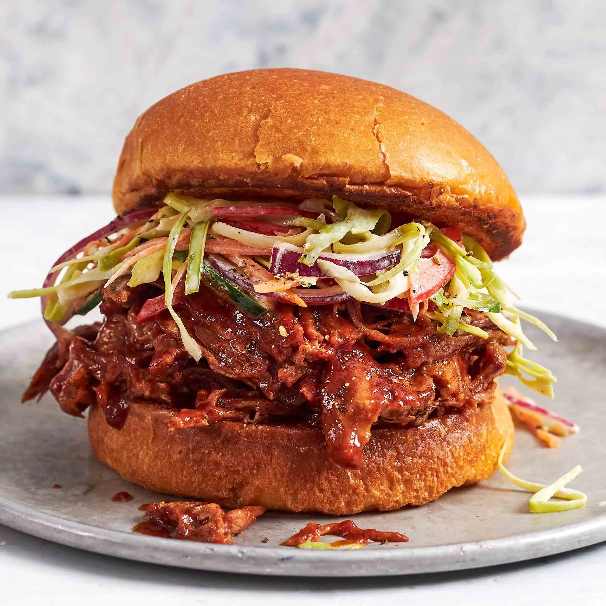 Pulled pork sandwich on a sourdough sesame bun