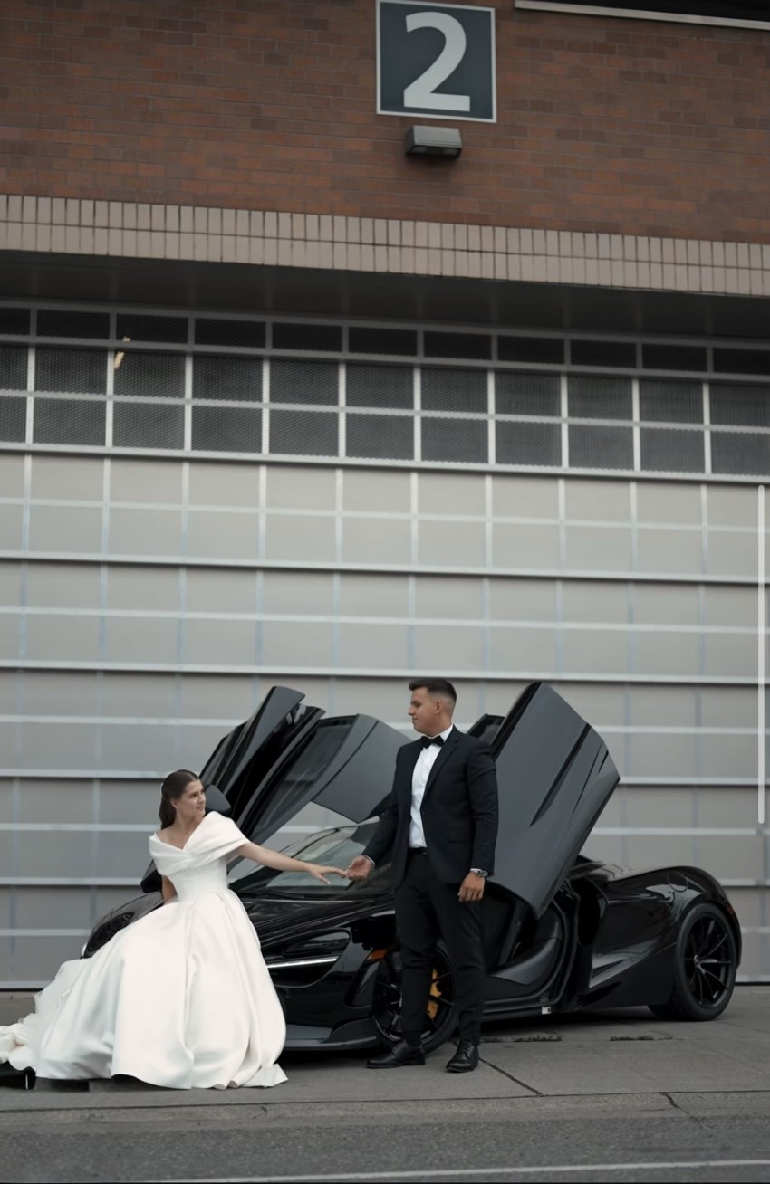 Bride and groom with a black McLaren 720S on their wedding day