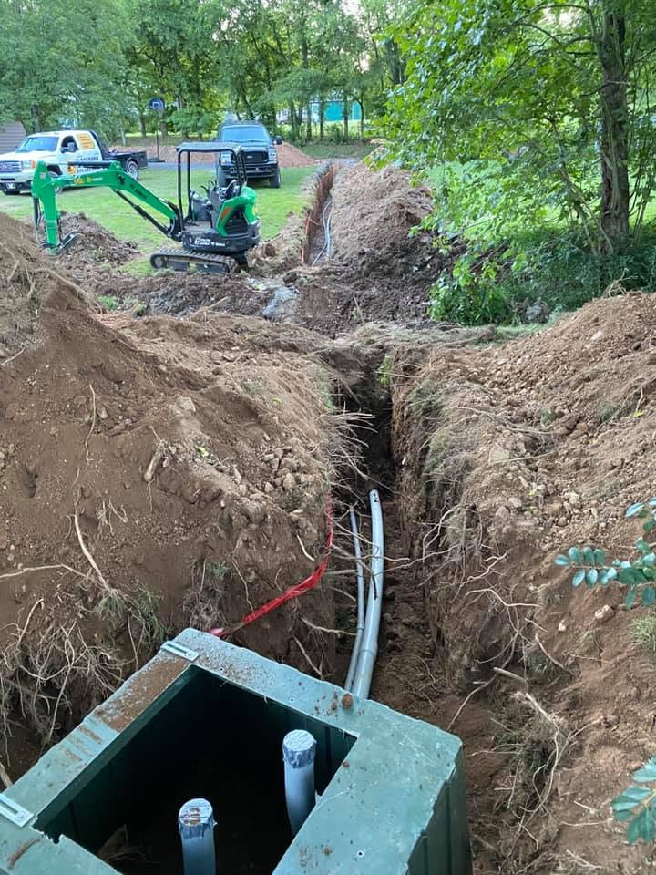 Underground utility trench with installed pipe and compact equipment on a residential property