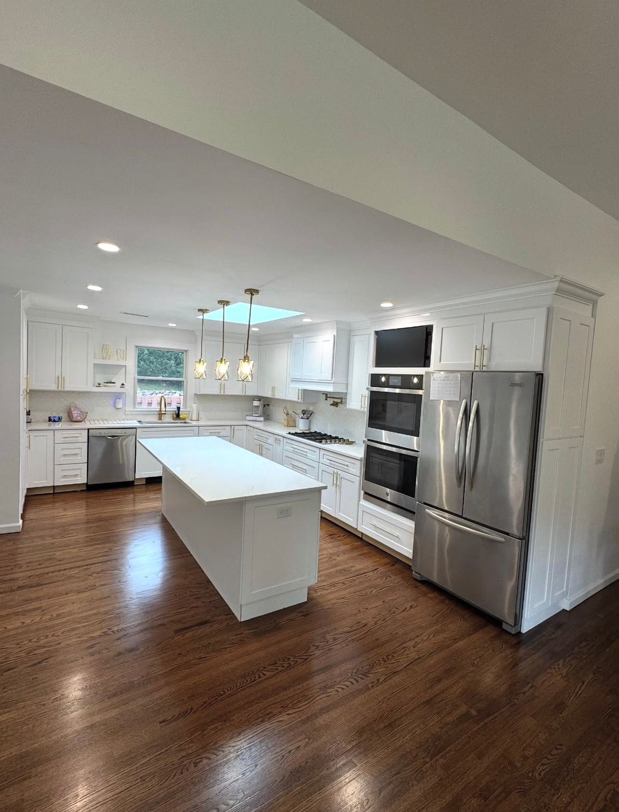 Large center island in a Westchester kitchen remodel with oak floors and quartz countertops