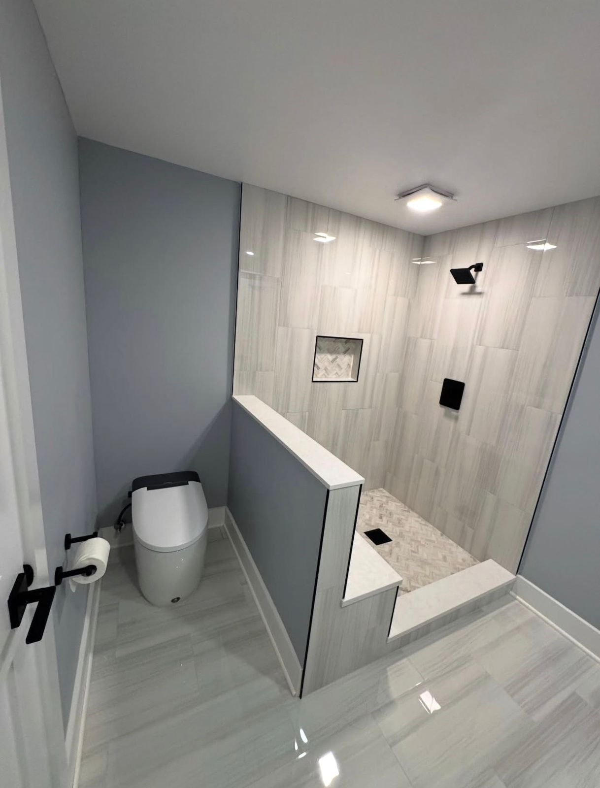 Modern bathroom remodel in White Plains NY with floating vanity and clean white finishes by Buff Builds