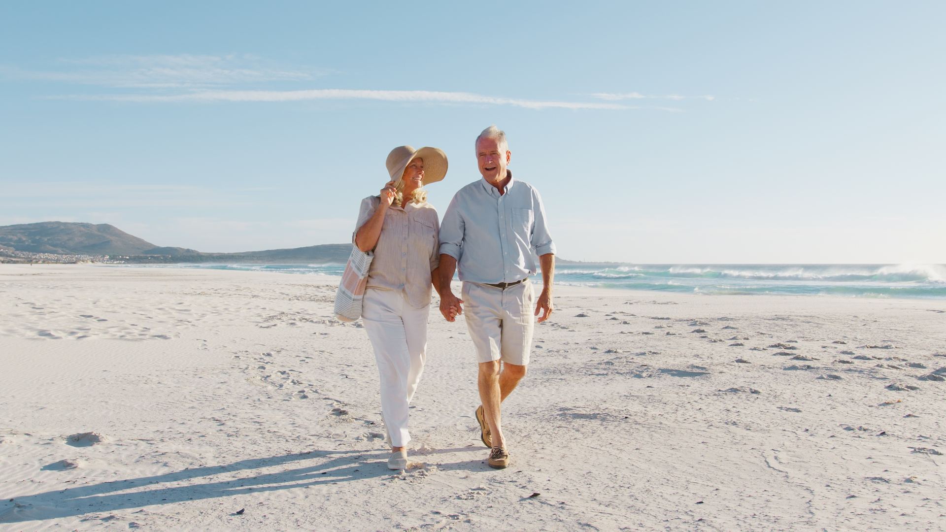 Couple walking together on a sunny beach